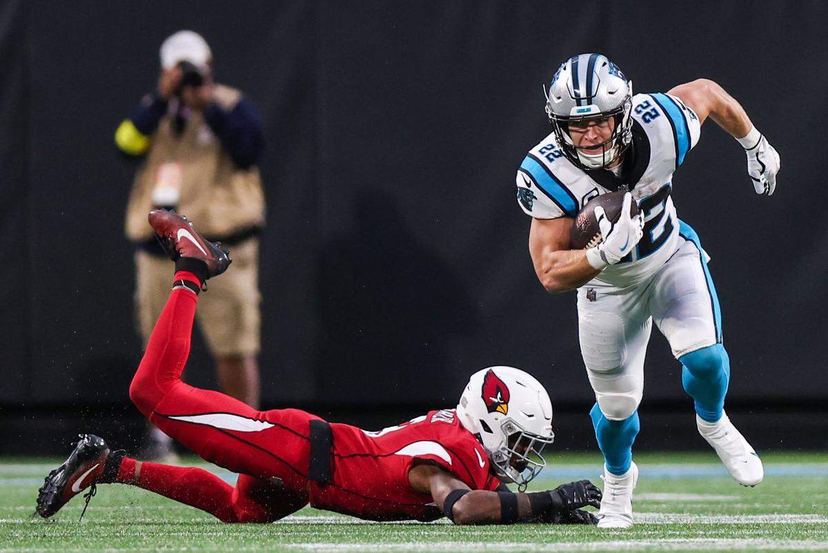 Panthers running back Christian McCaffrey finds a hole in the line to run downfield during the game against the Cardinals on Sunday, October 2, 2022, 2022 in Charlotte, NC.