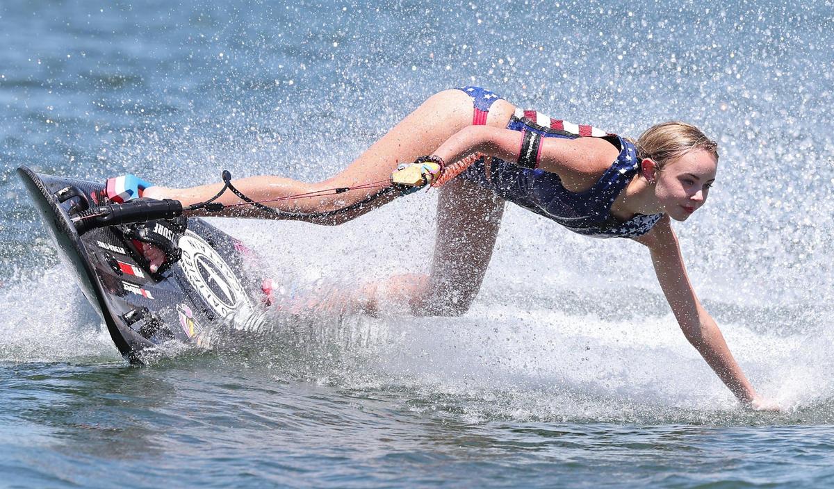 Anna Burk rides her 45-pound motosurf board. The boards have a carbon fiber hull and a 100 cc fuel-injected, 2-stroke motor that generates 16 horsepower. Her board cost $13,000.