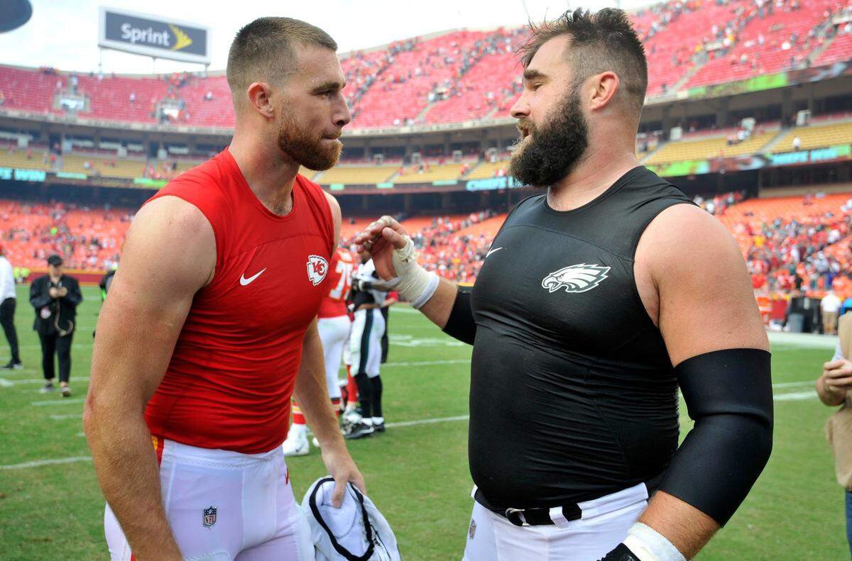 FILE - Kansas City Chiefs tight end Travis Kelce, left, talks to his brother, Philadelphia Eagles center Jason Kelce, after they exchanged jerseys following an NFL football game in Kansas City, Mo., on Sept. 17, 2017. For the first time in Super Bowl history, a pair of siblings will play each other on the NFL’s grandest stage. Travis helped the Chiefs return to their third championship game in four seasons on Sunday night when they beat the Bengals for the AFC title, while Jason has the Eagles back for the second time in six years after their NFC title win over the 49ers.