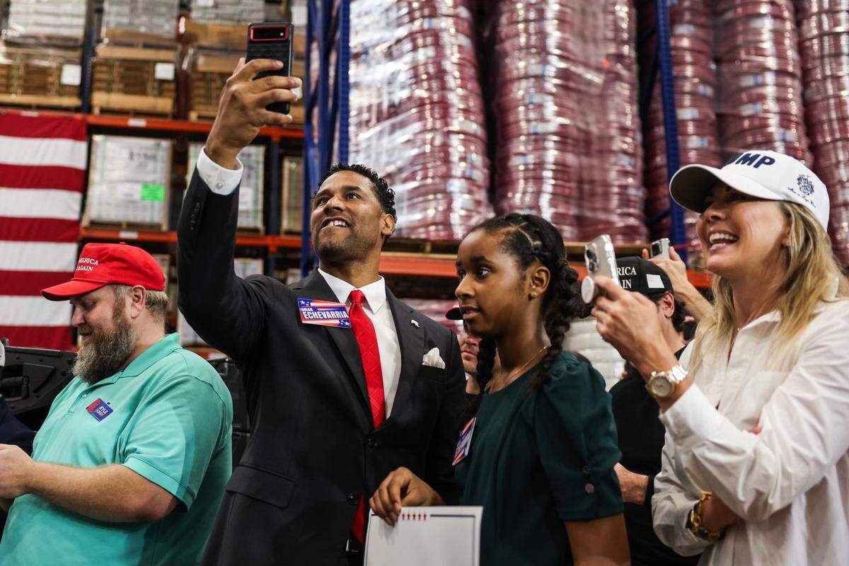 Supporters videotape as former President Donald Trump speaks at a campaign rally inside the Mosack Group manufacturing warehouse in Mint Hill, NC on Wednesday, September 25, 2024.