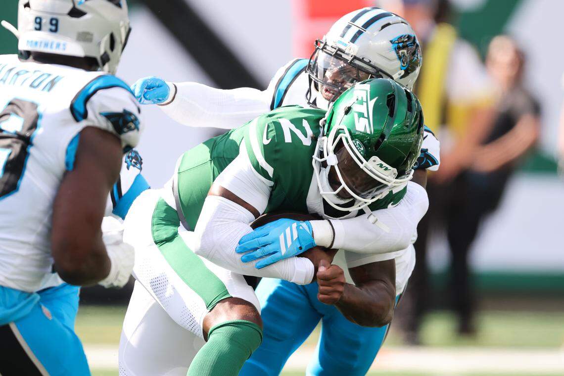 New York Jets quarterback Tyrod Taylor (2) is sacked by Carolina Panthers safety Nick Scott (21) in the second quarter on Sunday in New Jersey.