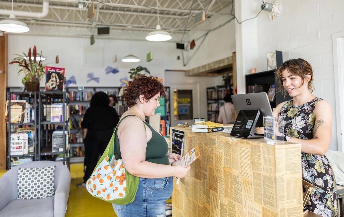Alyssa Pressler, owner of That’s Novel Books, right, checks out Theo Palermo who just happened to stumble upon the Greater Charlotte Book Crawl.