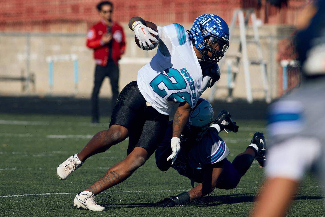 Maiden ATH Shannon Wingate (2) carries the ball and tries to avoid a tackle in the Queen City Senior Bowl hosted at Olympic High School.