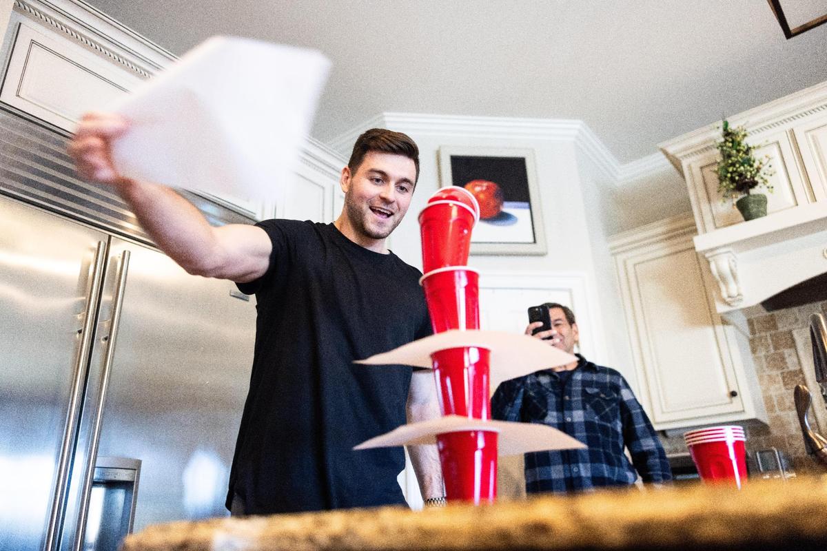 Alex Presley demonstrates a game that he’s showcased in his viral videos as his dad, Lee, captures the moment.