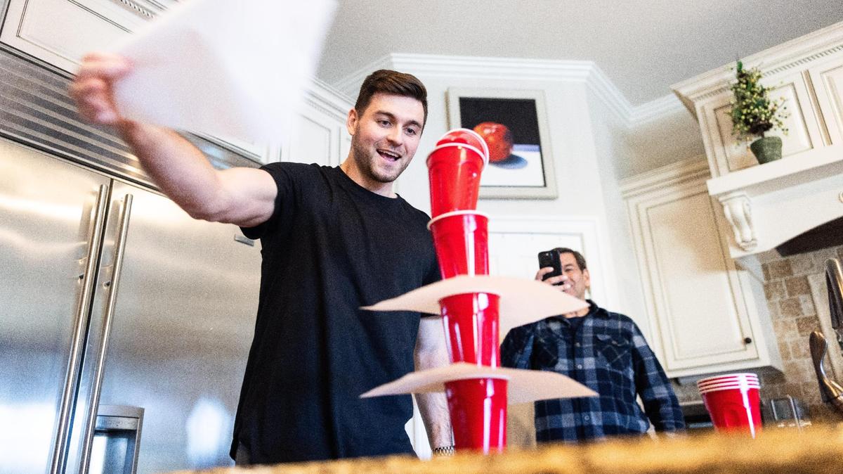Alex Presley demonstrates a cup game that he plays in his TikTok videos in Cornelius, N.C., on Wednesday, January 17, 2024.