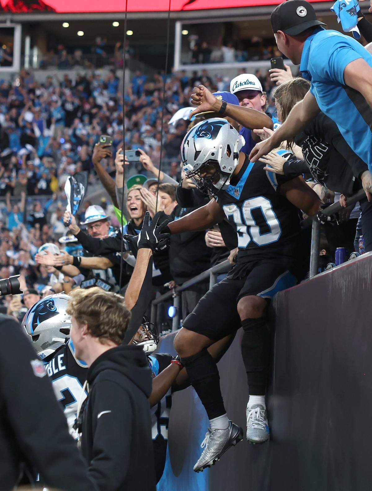 Panthers running back Chuba Hubbard, center, celebrates his touchdown run with the fans and scoring a touchdown against the Rams on Jan. 10, 2026, at Bank of America Stadium in Charlotte. 