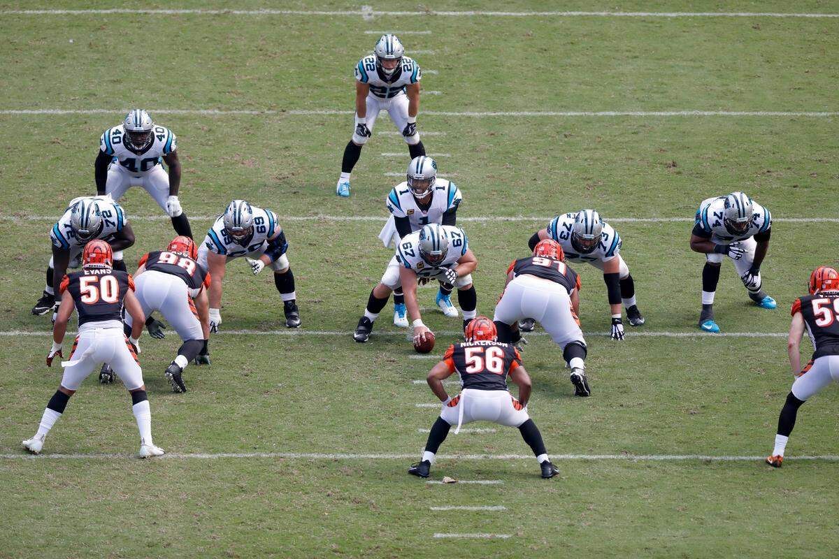 Carolina Panthers quarterback Cam Newton (1) goes under center to receive a snap as Chris Clark (far right, No. 74) prepares to protect Newton’s blind side. Clark once played the same role for Peyton Manning at Denver.
