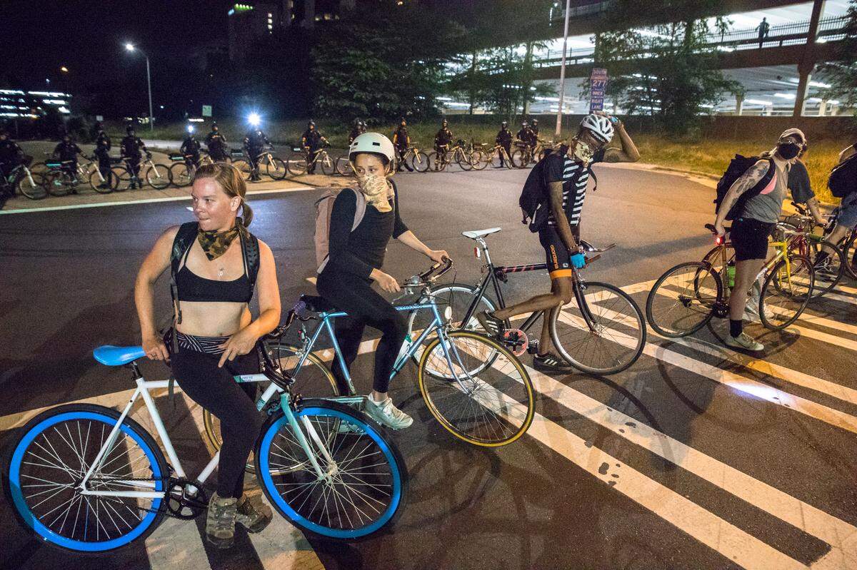 Volunteers with bikes manage traffic on Day 9 of protests.
