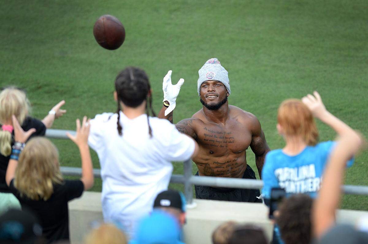 Carolina Panthers linebacker Denzel Perryman plays catch with fans along the sideline of Gibbs Stadium in Spartanburg, SC on Saturday, July 31, 2021. The team held their practice at Gibbs Stadium as part of the NFLÕs Training Camp: Back Together Saturday celebrating the return of fans and football.