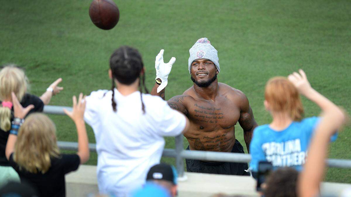 Carolina Panthers linebacker Denzel Perryman plays catch with fans along the sideline of Gibbs Stadium in Spartanburg, SC on Saturday, July 31, 2021. The team held their practice at Gibbs Stadium as part of the NFLÕs Training Camp: Back Together Saturday celebrating the return of fans and football.