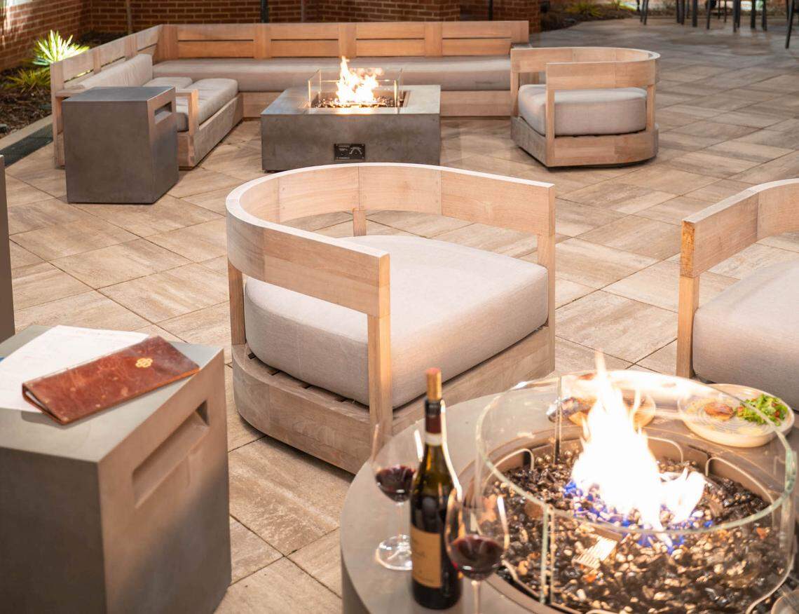 Golden Owl Tavern has outdoor fire pits and heat lamps on its wraparound patio facing the LNYX Blue Line University City Station.