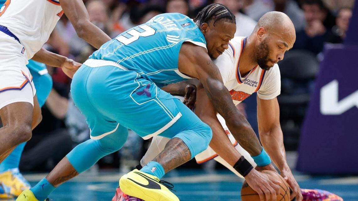 Charlotte Hornets guard Terry Rozier (3) and New York Knicks center Taj Gibson (67) battle for the ball during a game at Spectrum Center in Charlotte, N.C., Wednesday, March 23, 2022. New York defeated Charlotte 121-106.