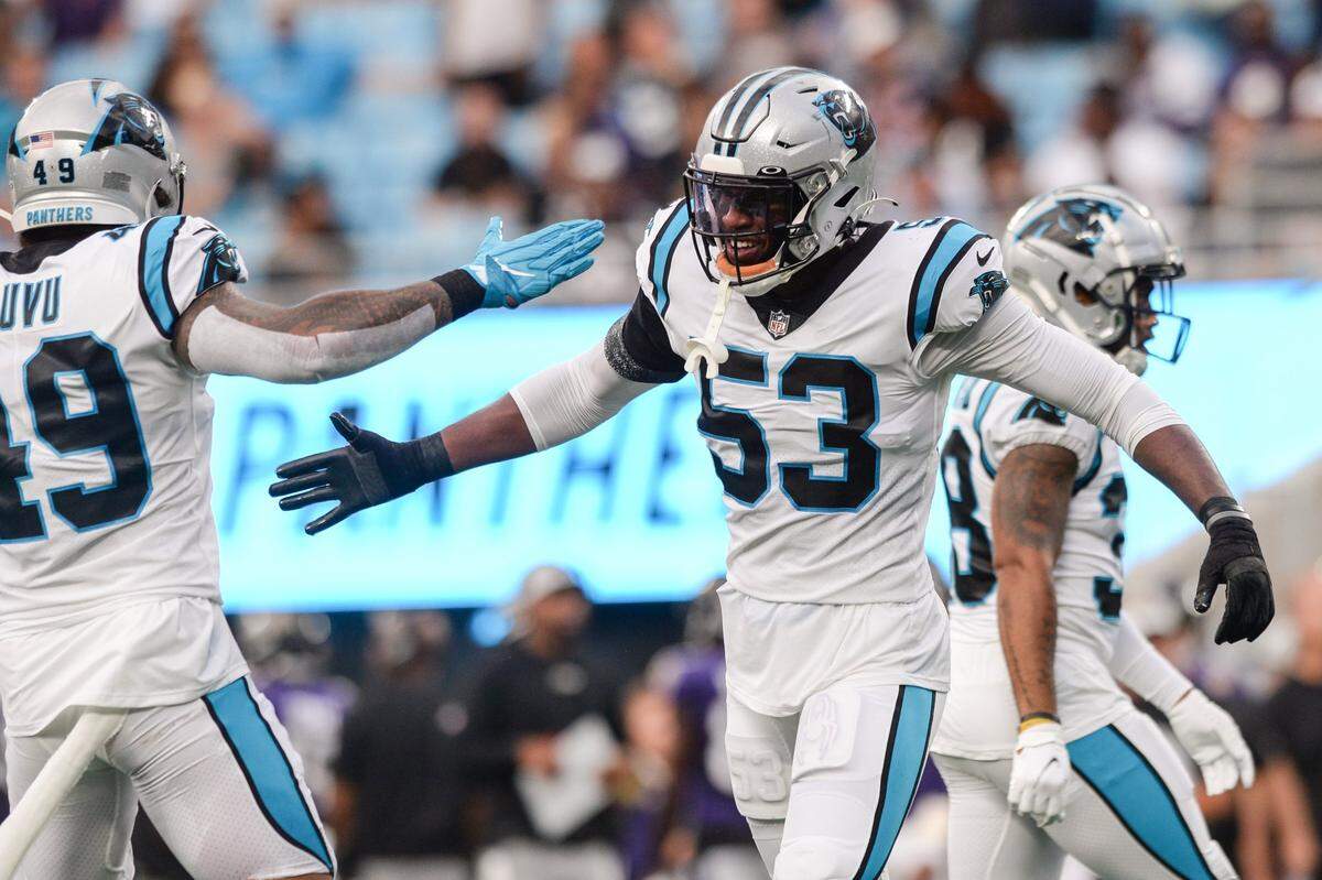 Panthers defensive end Brian Burns, center, celebrates his sack on Ravens quarterback Tyler Huntley during the first quarter of the pre-season game on Saturday, August 21, 2021 at Bank of America Stadium.