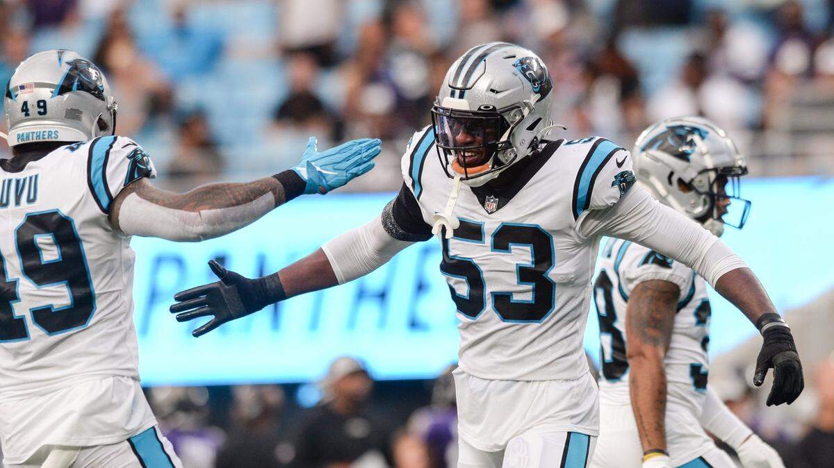 Panthers defensive end Brian Burns, center, celebrates his sack on Ravens quarterback Tyler Huntley during the first quarter of the pre-season game on Saturday, August 21, 2021 at Bank of America Stadium.
