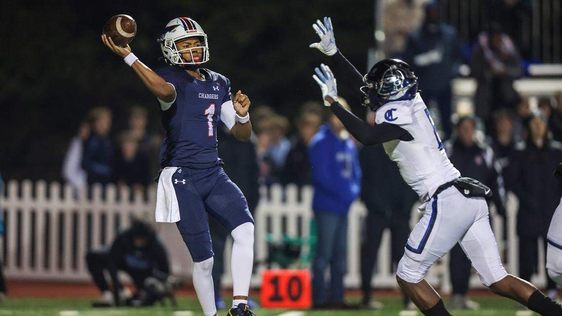 Providence Day’s Jadyn Davis, left, throws a pass during the game against Charlotte Catholic for the NCISAA state high school football championship on Friday, November 18, 2022.