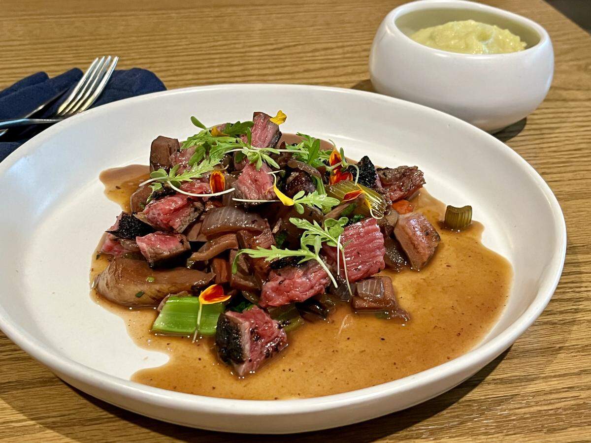 The wagyu flank blankets the tender mushrooms and vegetables in this elevated stew at Restaurant Constance.