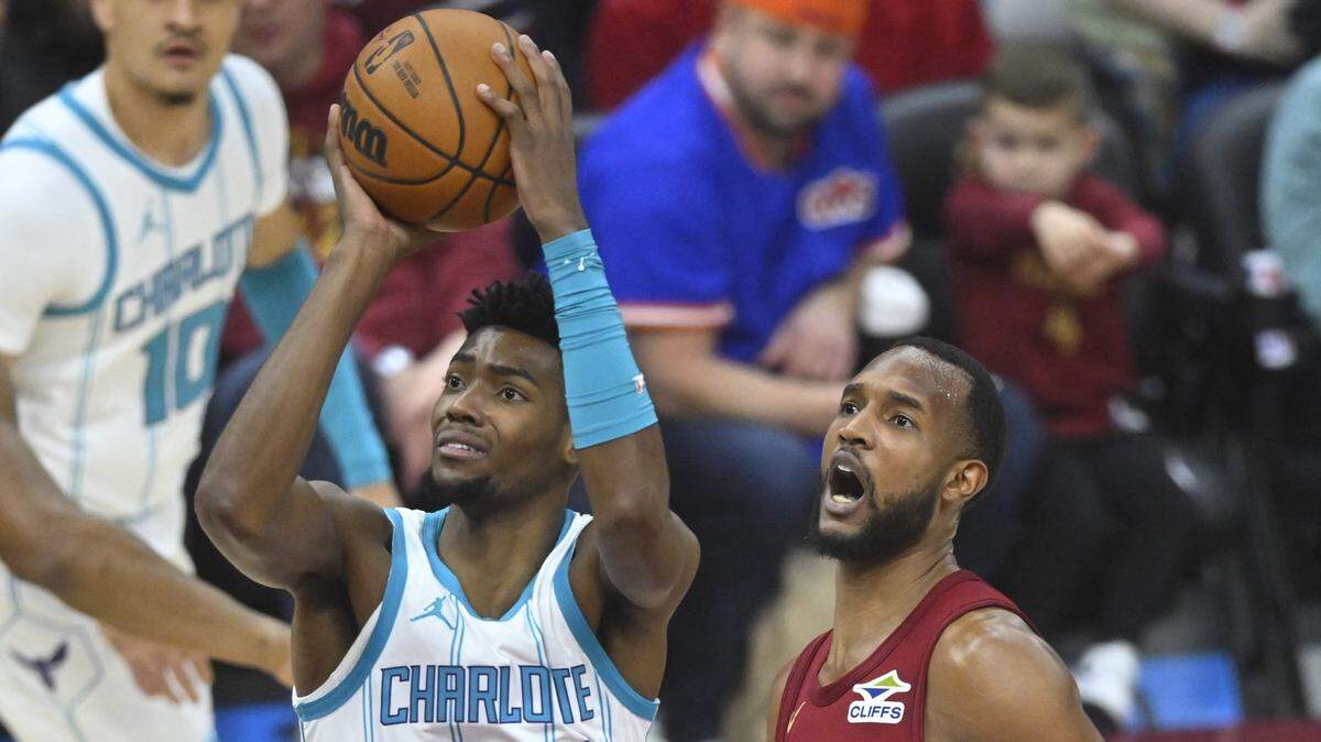 Charlotte Hornets forward Brandon Miller (24) shoots beside Cleveland Cavaliers forward Evan Mobley (4) in the first quarter at Rocket Mortgage FieldHouse.