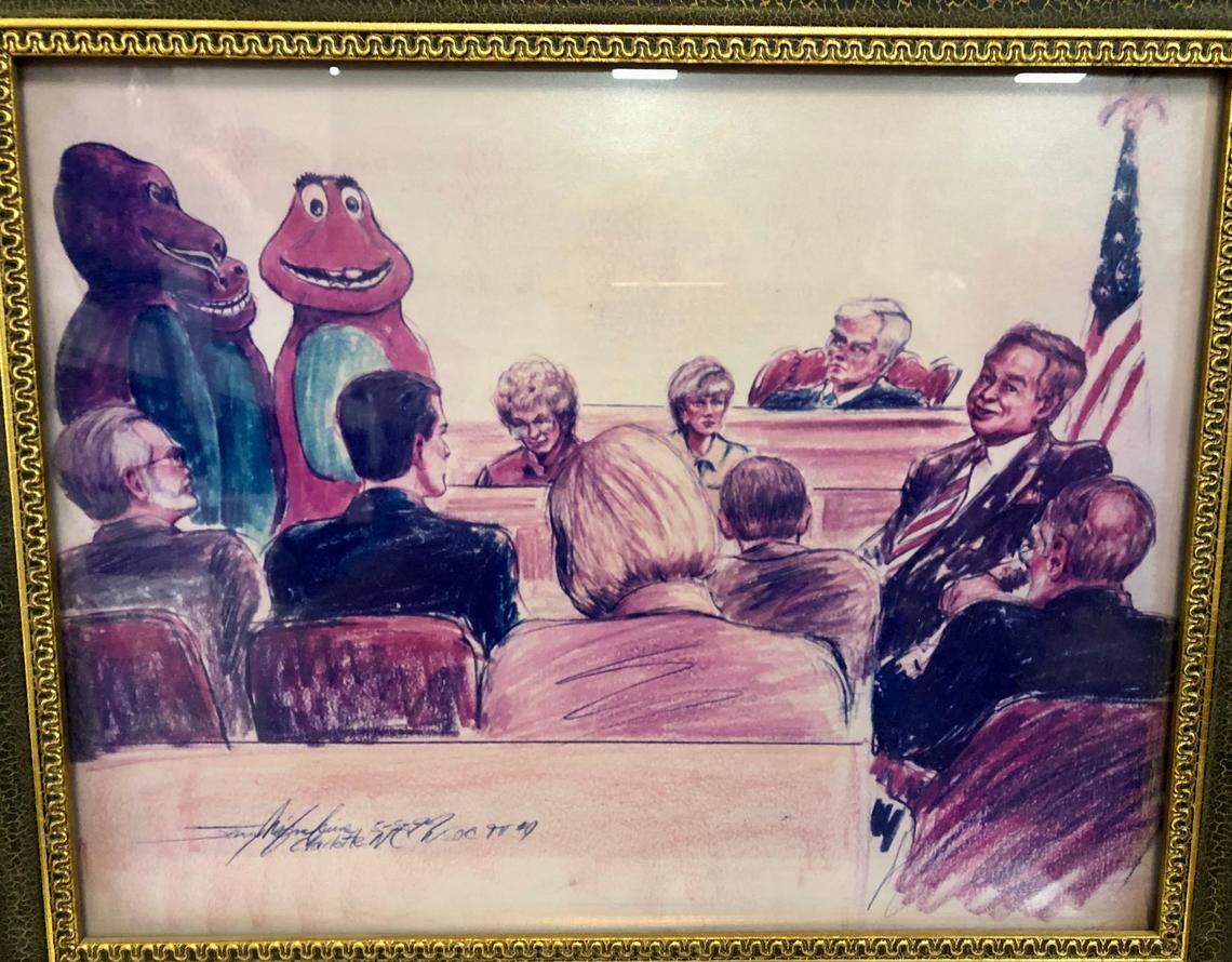 A framed copy of a sketch by courtroom artist Jerry McJunkins, who captured the moment when attorney Jay Bilas subpoenaed the “Barney the Dinosaur” costume for trial in Charlotte.