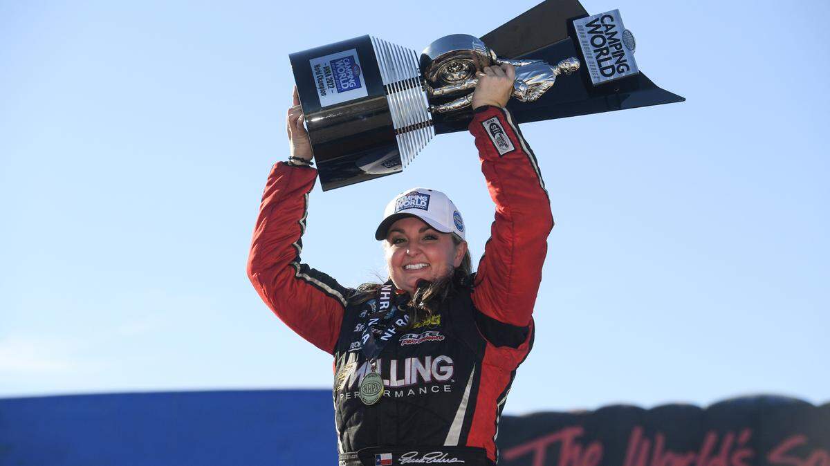 Erica Enders raises the trophy after winning in Las Vegas in 2022.