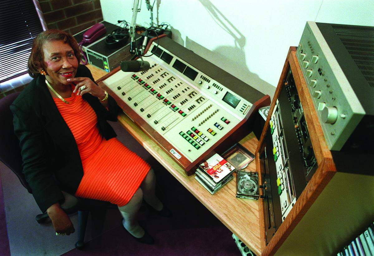 “Chatty” Hattie Leeper, the first Black woman to be a radio host in North Carolina and new inductee into the North Carolina Association of Broadcasters’ Hall of Fame. Leeper, who is well known from her time on the air at WGIV-AM in the 1950’s and 1960’s, later ran the broadcasting dept. at Gaston College. She now runs her own school, Chatty’s School of Communication. Photo of Chatty in the broadcasting room of her school.
