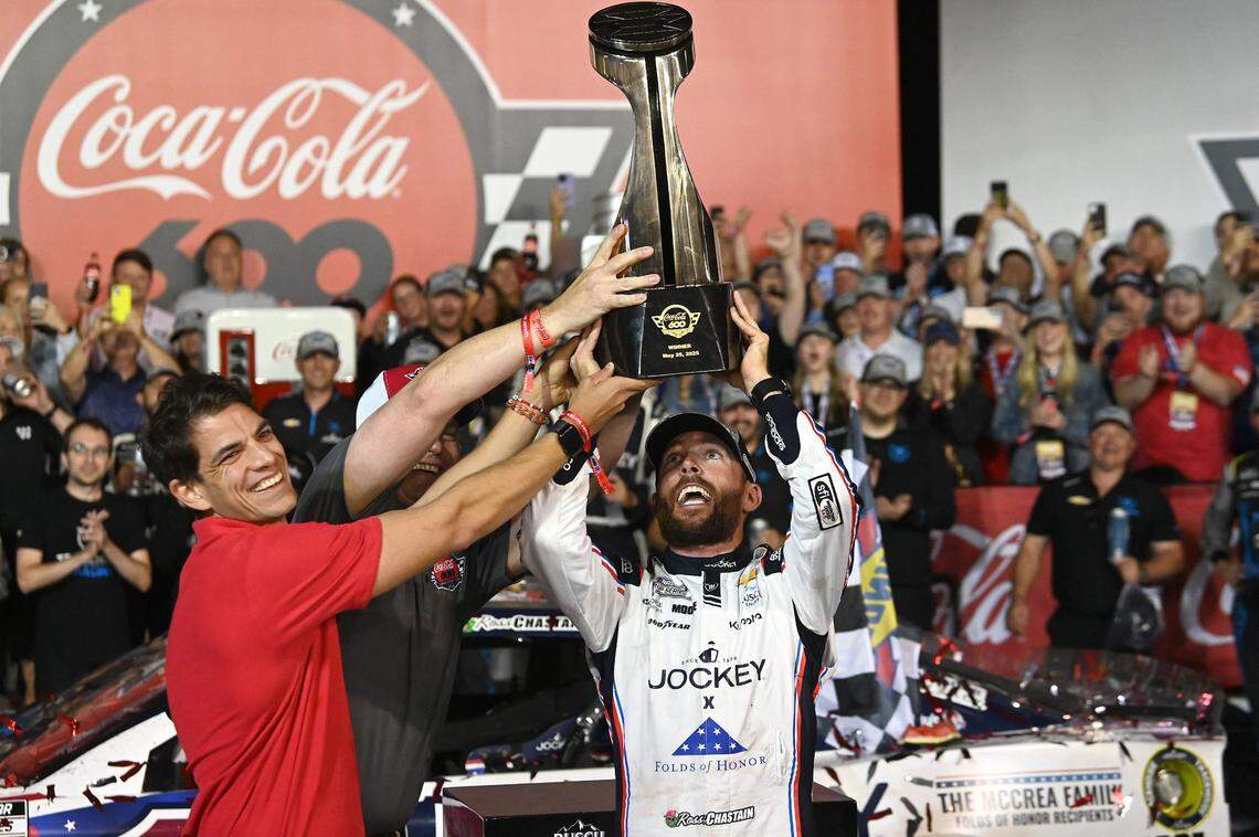 NASCAR Cup Series driver Ross Chastain gets some assistance lifting the Coca-Cola 600 trophy Sunday night in Victory Lane at Charlotte Motor Speedway in Concord.