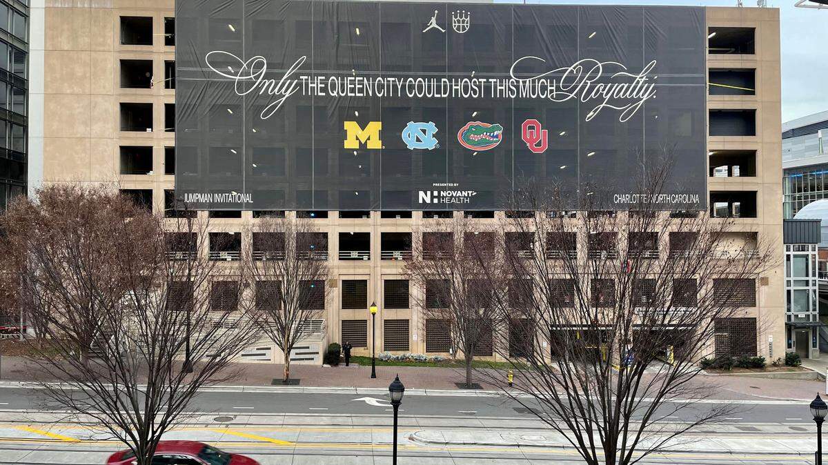 A banner towers above East Trade Street in the heart of Uptown Charlotte just outside of the Spectrum Center ahead of the Jumpman Invitational. It reads, “Only the Queen City can host this much royalty.”