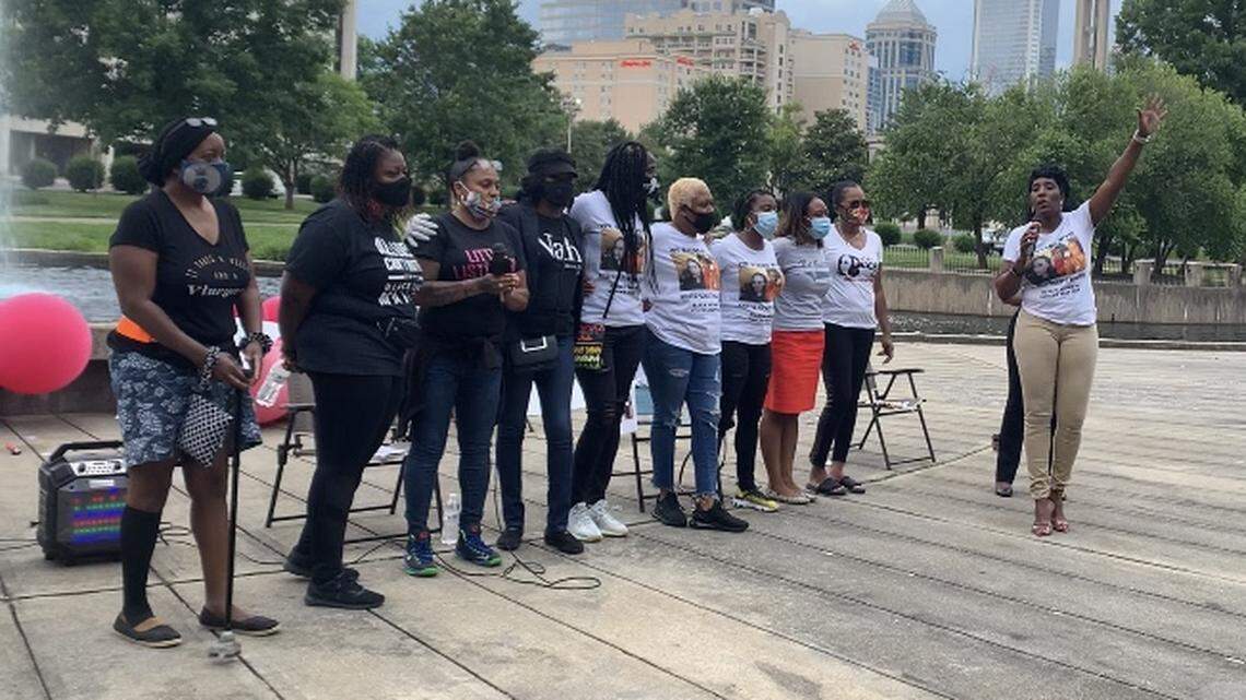 Panelists stand together at the end of the “Black Women United” discussion in Marshall Park on Thursday, June 18, 2020.