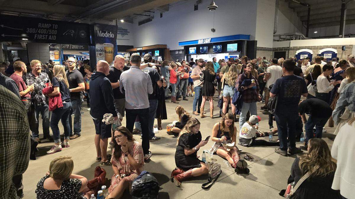 Attendees for Concert for Carolina wait in the concourse of Bank of America Stadium as inclement weather was cause for an evacuation until conditions clear in Charlotte on Saturday.