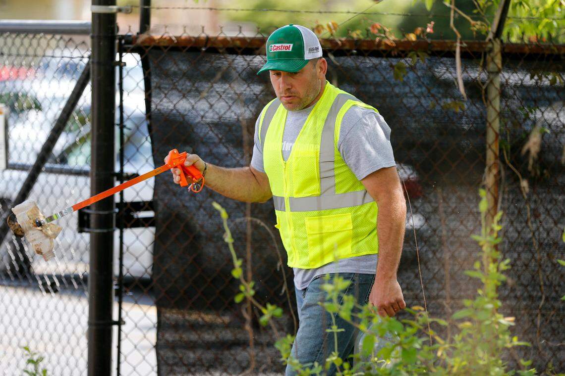 NASCAR driver Ryan Newman picks up trash alongside Alleghany Street in Charlotte on April 13.
