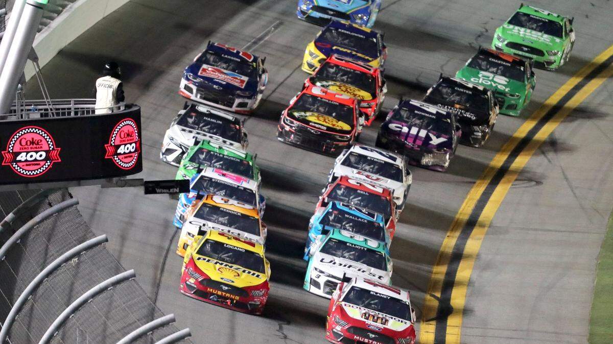 Joey Logano, front left, and Ryan Blaney, front right, lead the field near the end of Stage 2 of the NASCAR Cup Series auto race at Daytona International Speedway, Saturday, Aug. 28, 2021, in Daytona Beach, Fla. (AP Photo/David Graham)