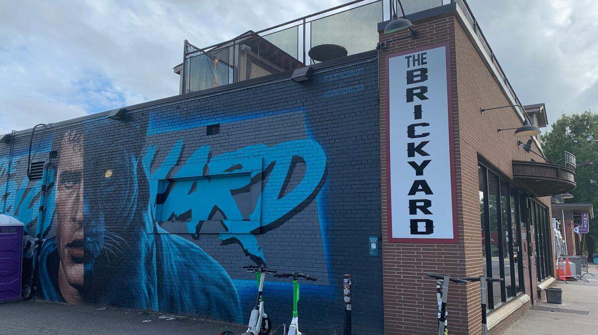Electric scooters sit outside of Brickyard, a popular bar in South End Charlotte.