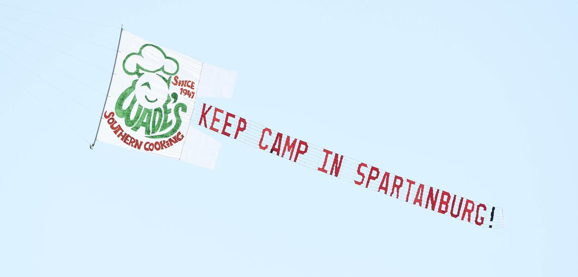 A plane tows a banner above the first practice of Carolina Panthers training camp for 2018 at Wofford College, asking new owner David Tepper to keep camp in Spartanburg.