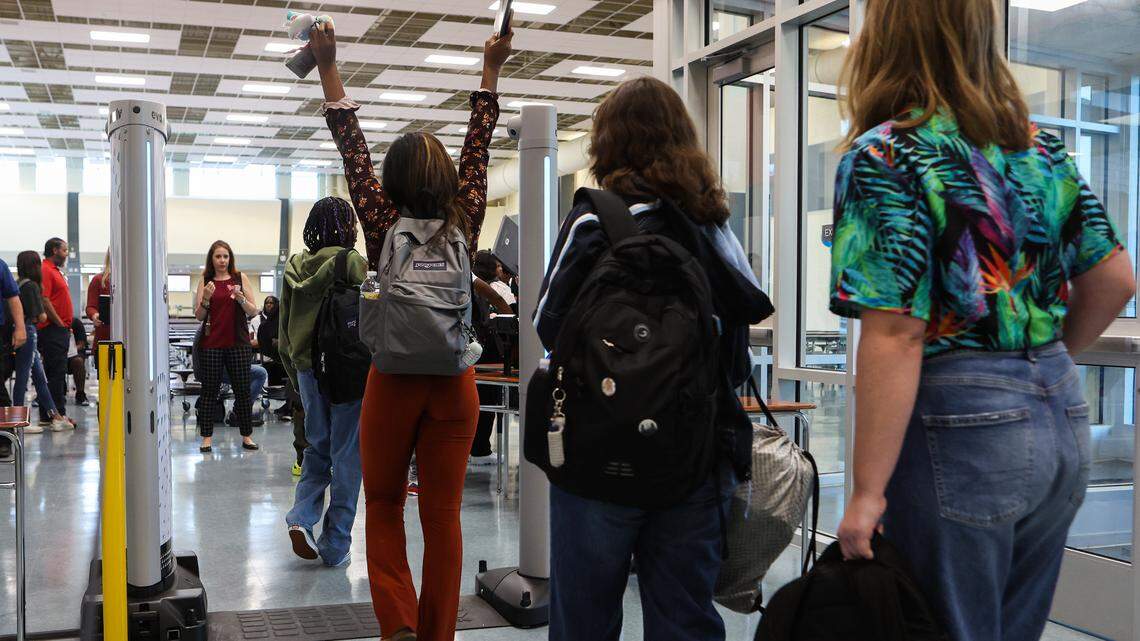 Students at Palisades High School in Charlotte, N.C., walk through a body scanner on August 29, 2022.