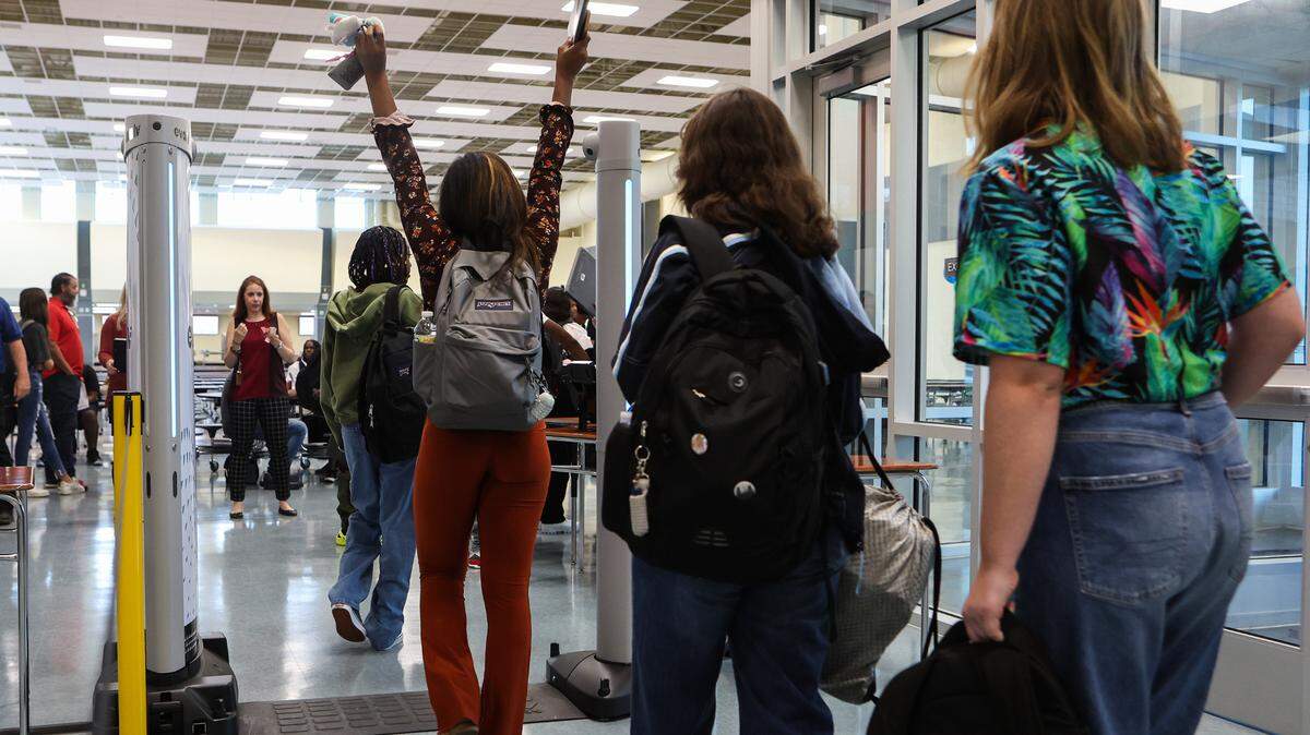 To enhance school safety, Charlotte-Mecklenburg Schools has installed body scanners in 21 high schools, including North Mecklenburg High. In this photo students at CMS’s newest campus, Palisades High, walk through a scanner on August 29, 2022.