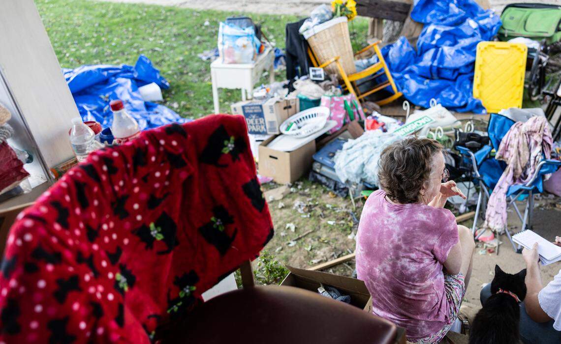 Wanda Wells sits on her porch In October 2024 after cleaning out her home in Canton. Her town was hit by flooding after Helene struck western North Carolina.