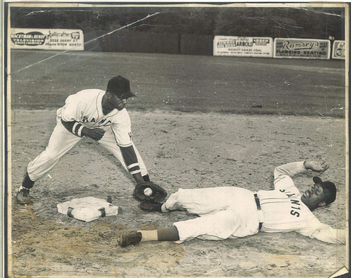 Former Negro Leagues player Eddie ‘G.G.’ Burton, seen here tagging a base runner in an undated photo.