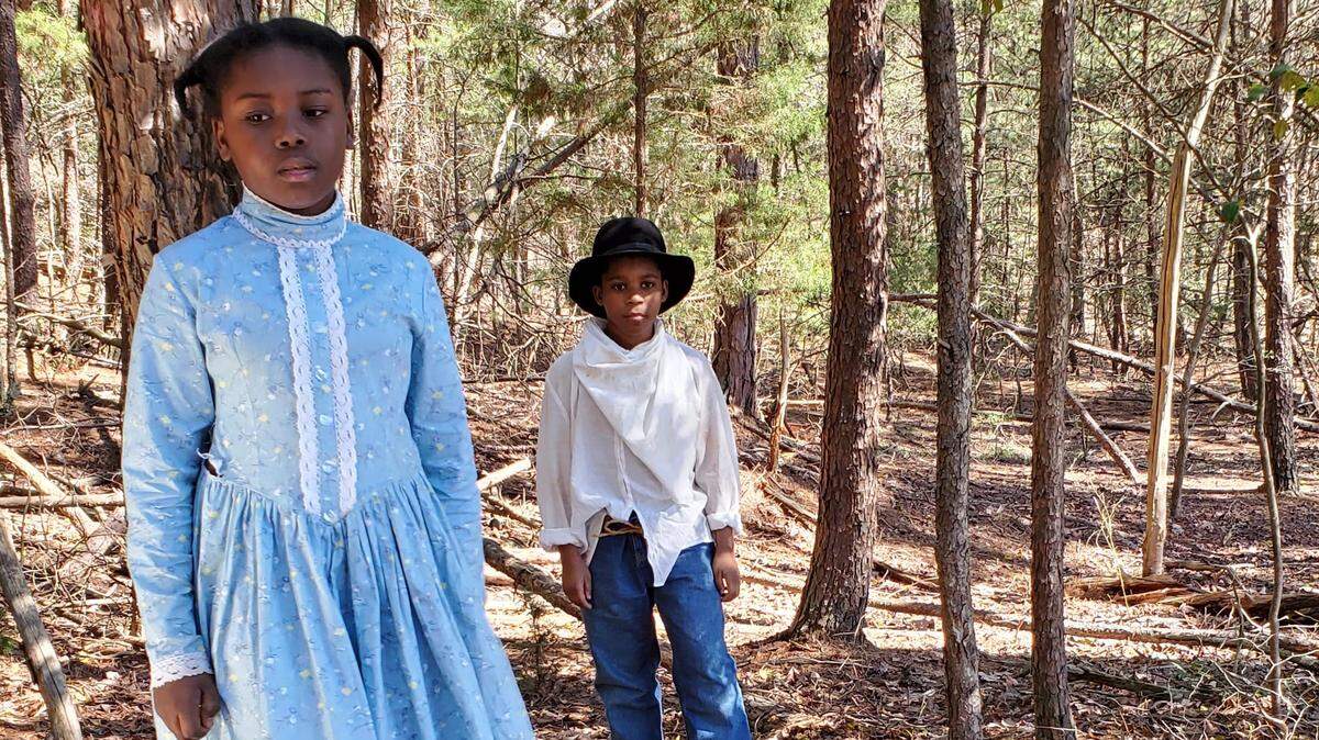 Yanna Buttons, 11, of New York, and Aidan Wallace, 12, of Charlotte, play friends in Ronald Dolphus’ film ”Lessons From Ebenezer Creek.” It blends the true story of Union soldiers turning on a formerly enslaved crowd with a fictional story about children who become friends on the path to freedom. 