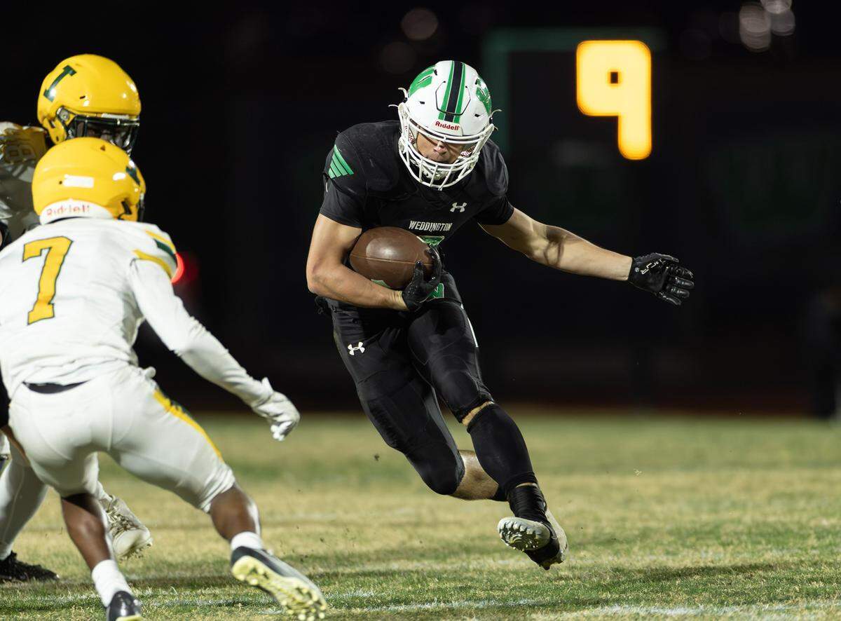 Weddington's Brody Anson (center) runs into a stiff Independence defense during 1st quarter action. Weddington would host Independence in the NCHSAA quarterfinal playoff game Friday, November, 28 2025.