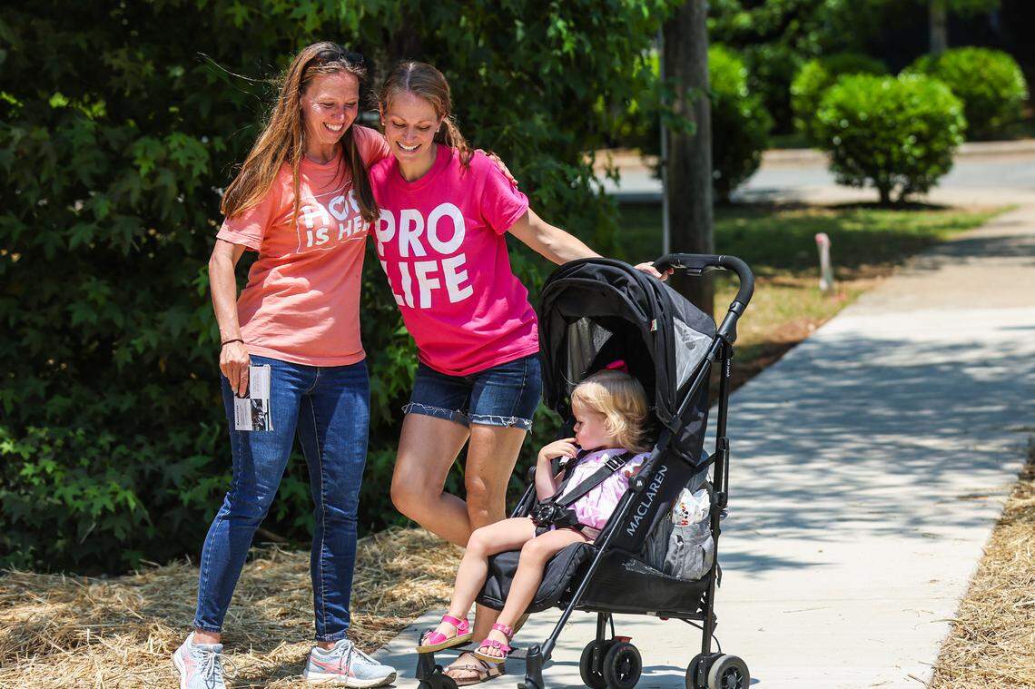Two women with Love Life embrace on the sidewalk outside A Preferred Women’s Health Center of Charlotte Friday. Earlier today the U.S. Supreme Court overturned Roe v. Wade, revoking women’s rights to have an abortion and shifting authority over the procedure to the states.