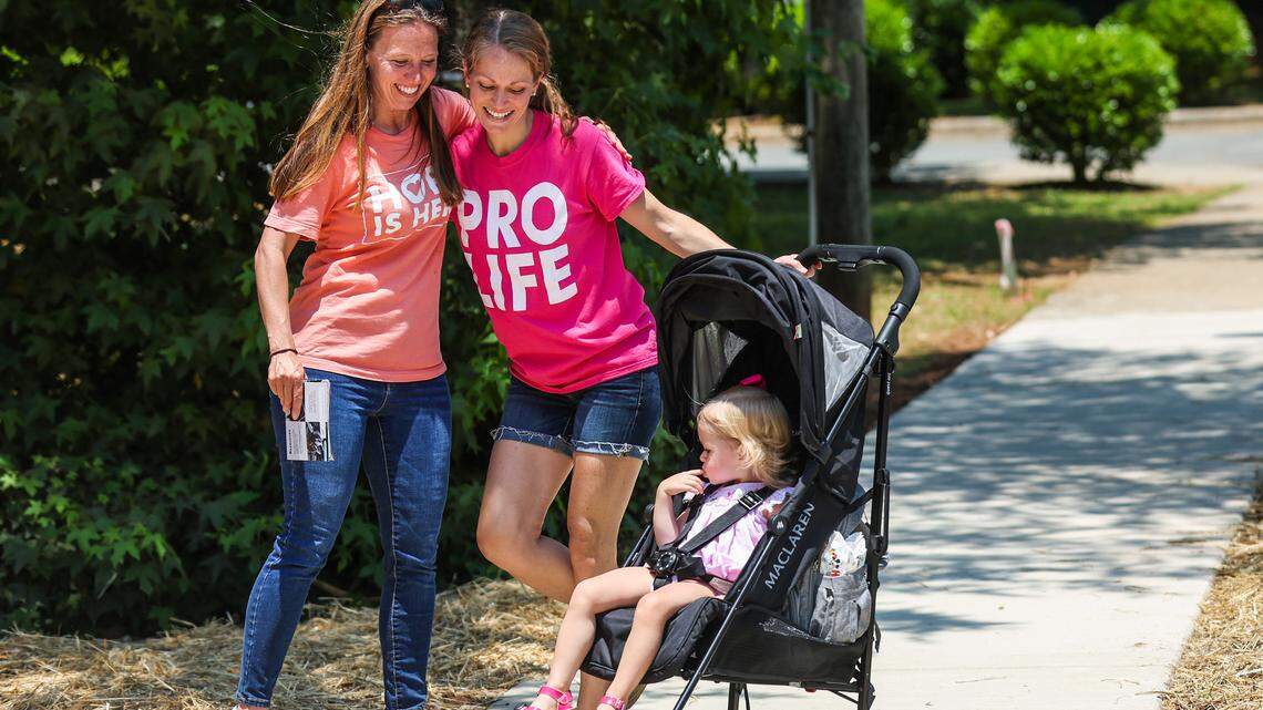 Two women with Love Life embrace on the sidewalk outside A Preferred Women’s Health Center of Charlotte on Friday, June 24, 2022. Earlier today the U.S. Supreme Court overturned Roe v. Wade, revoking women’s rights to have an abortion and shifting authority over the procedure to the states.