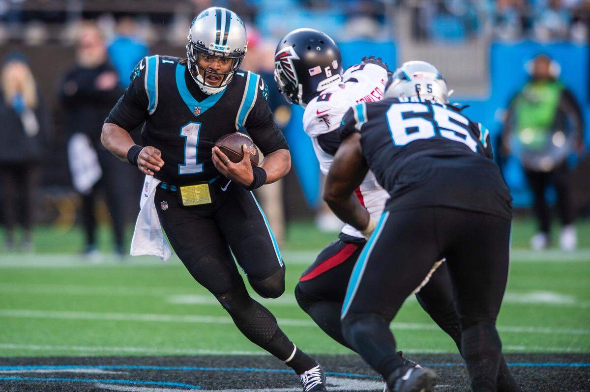 Panthers quarterback Cam Newton carries the ball on a quarterback keeper during the game against the Falcons at Bank of America Stadium on Sunday, December 12, 2021 in Charlotte, NC.