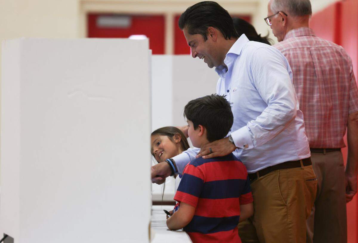 District 6 Charlotte City Council Member Tariq Bokhari votes with his family at Alexander Graham Middle School in Charlotte, N.C., on Wednesday, July 26, 2022. 