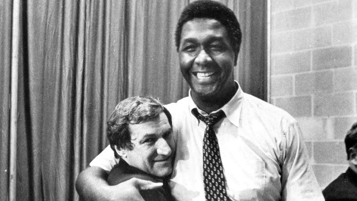 Georgetown coach John Thompson (right) hugs UNC coach and close friend Dean Smith after Smith’s Tar Heels defeated Thompson’s Hoyas, 63-62, in the 1982 NCAA championship game.