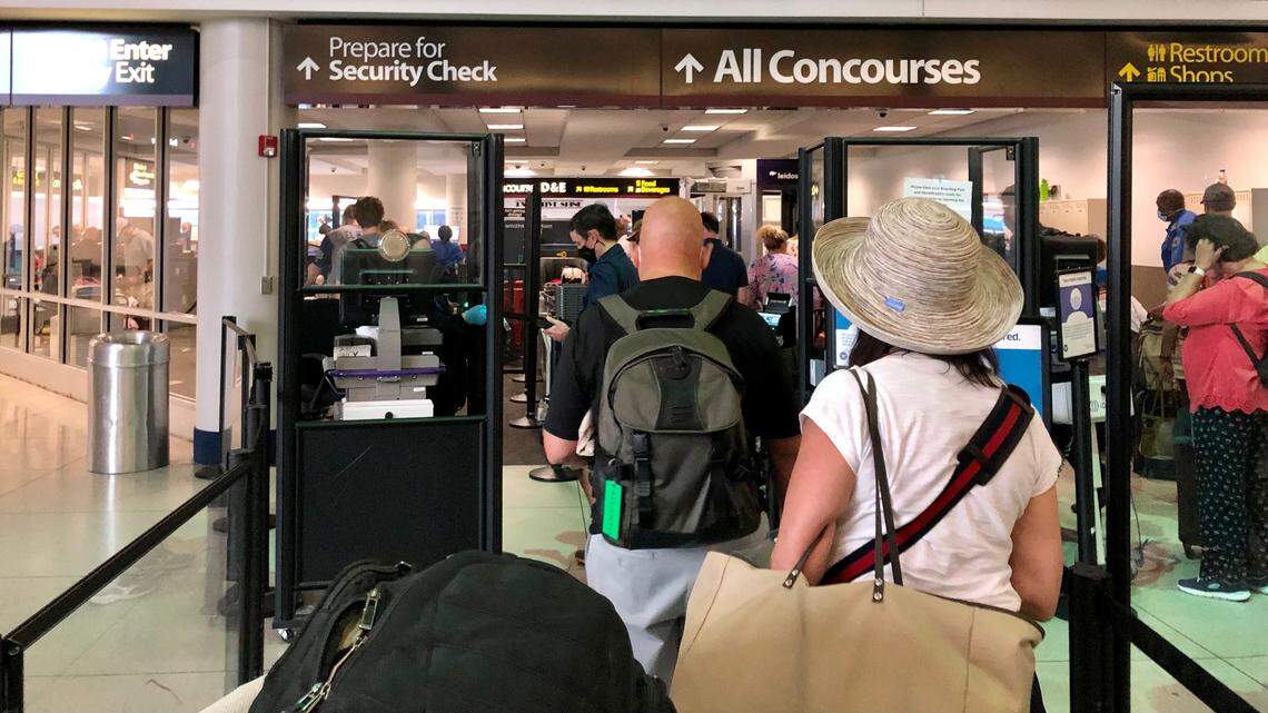 Local passengers line up at security at Charlotte Douglas International Airport in July 2021.