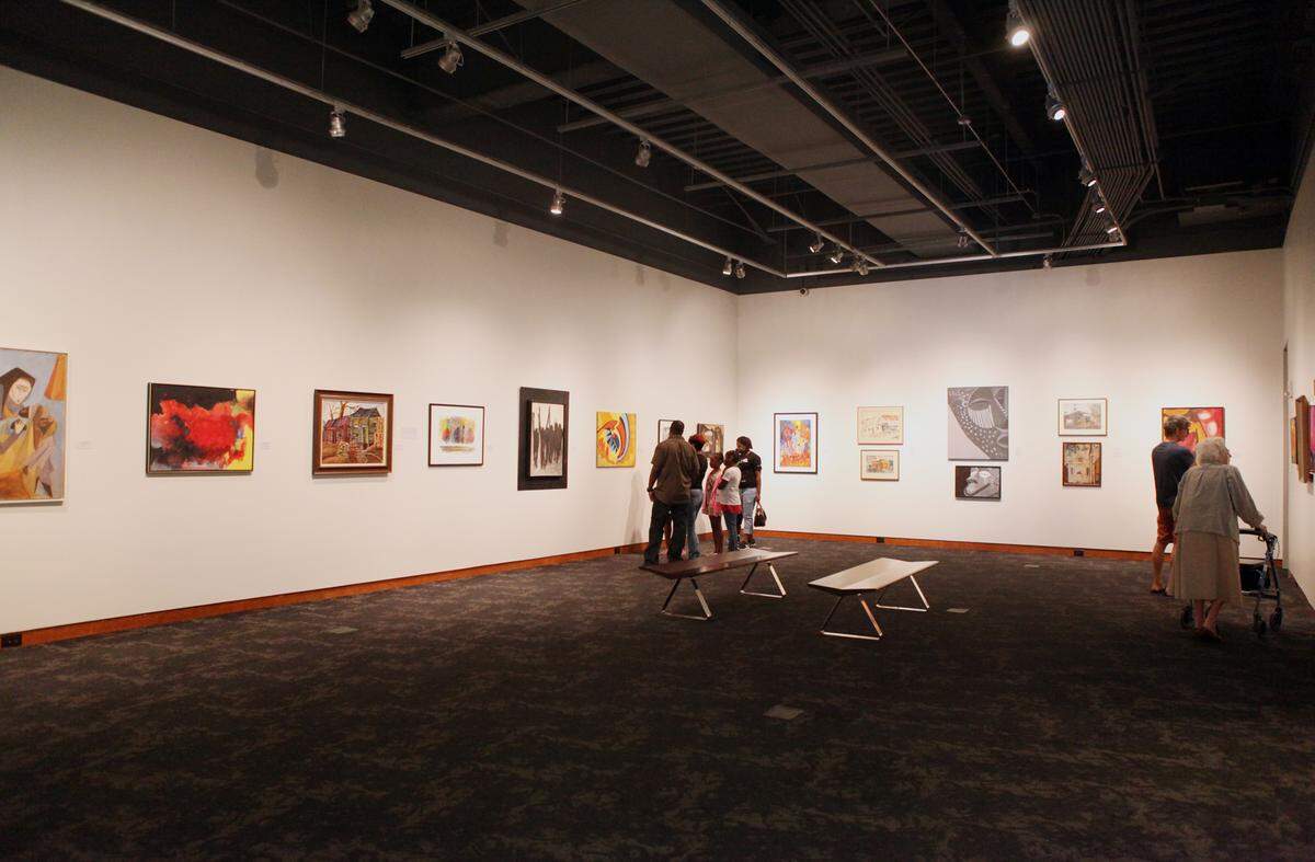 Families look at artwork in the downstairs gallery at the Gantt Center during a Family First event. 