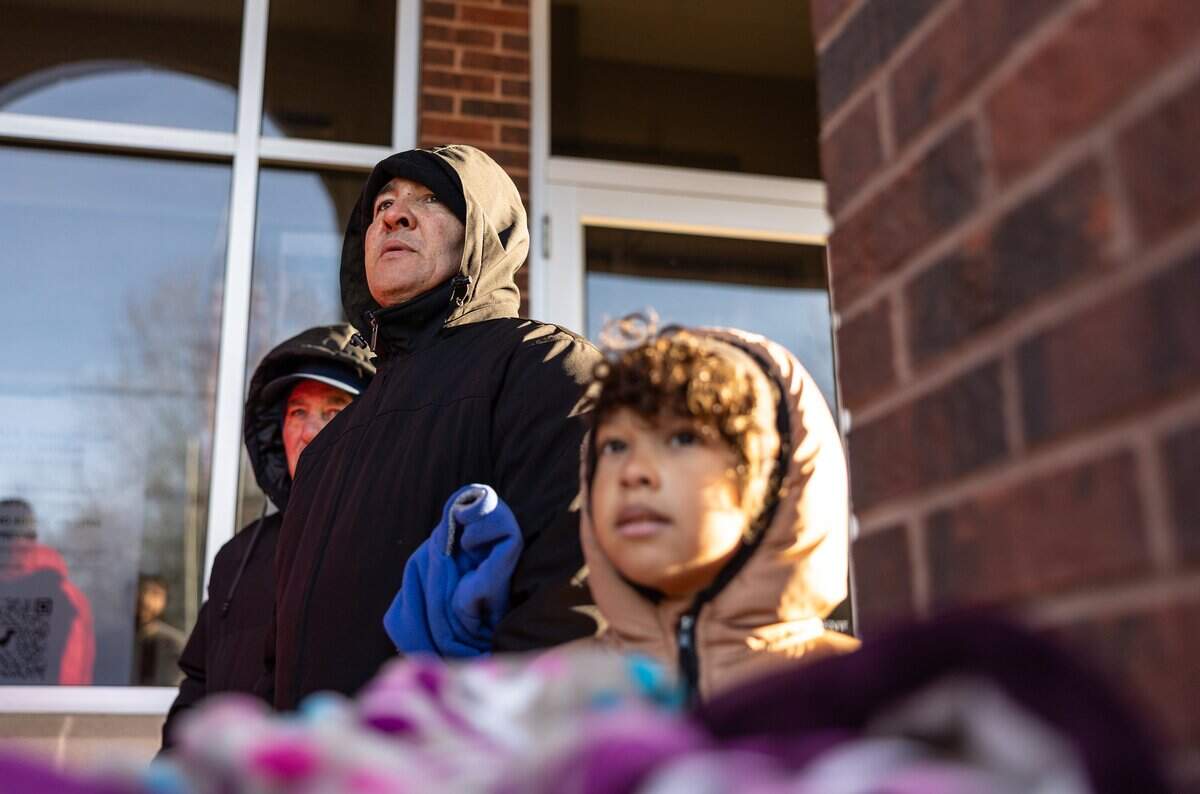 People wait outside of the Department Homeland Security office in Charlotte on January 21, 2026.