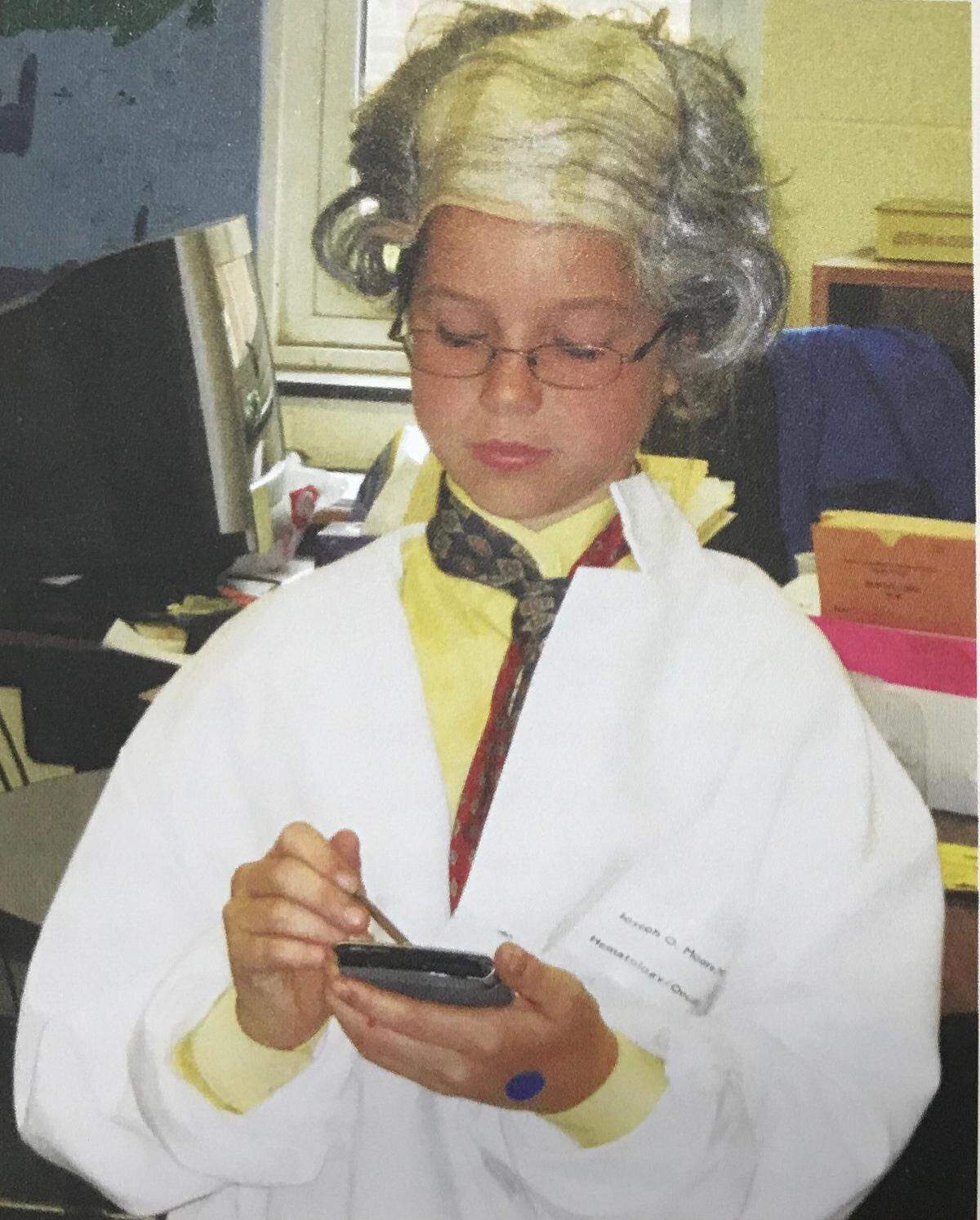 Grace Burud dresses up at her dad’s oncologist Dr. Joseph Moore for hero day at her elementary school.