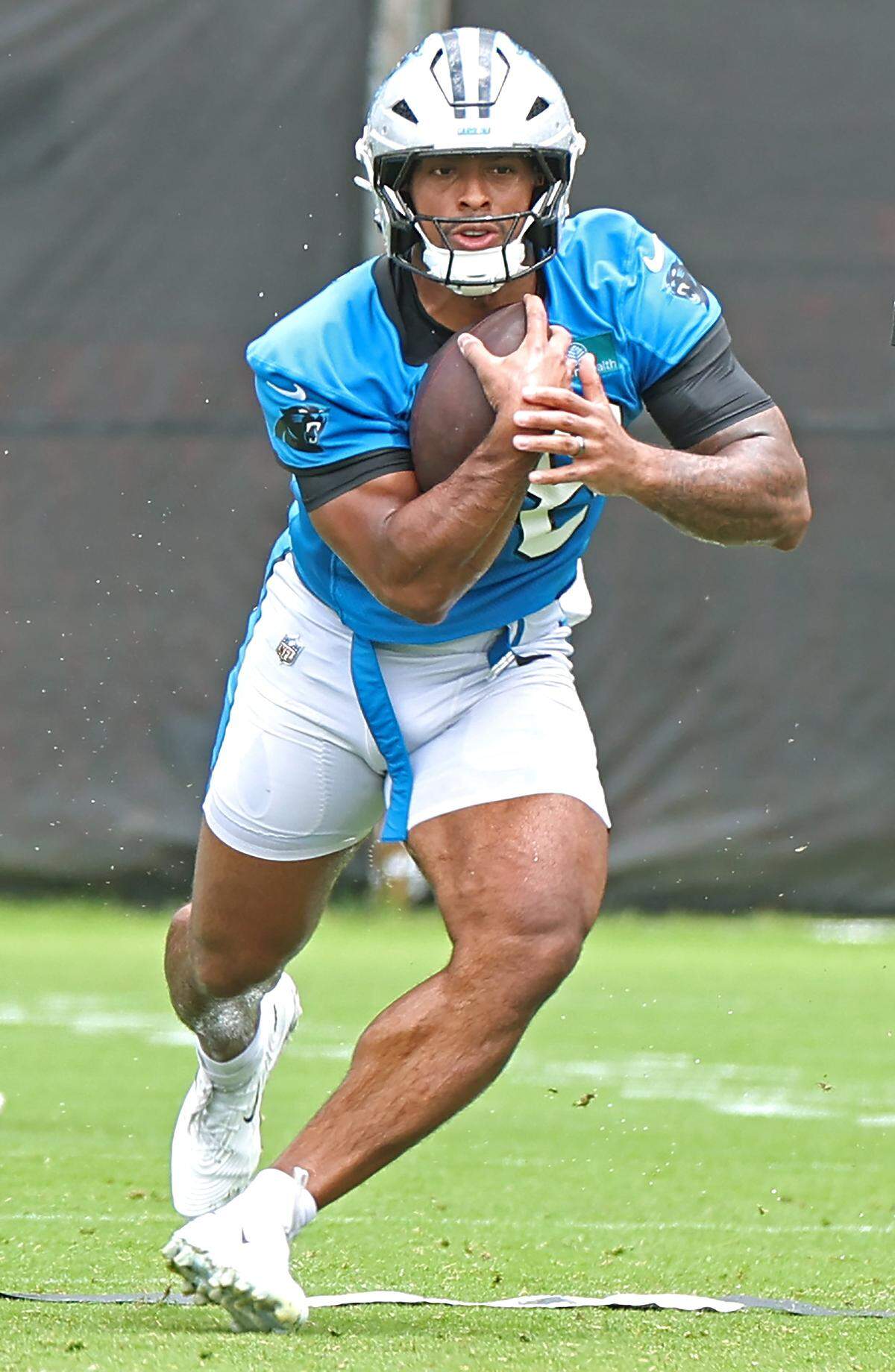 Carolina Panthers running back AJ Dillon begins to break upfield during the team's first open workout on Tuesday, May 26, 2026.