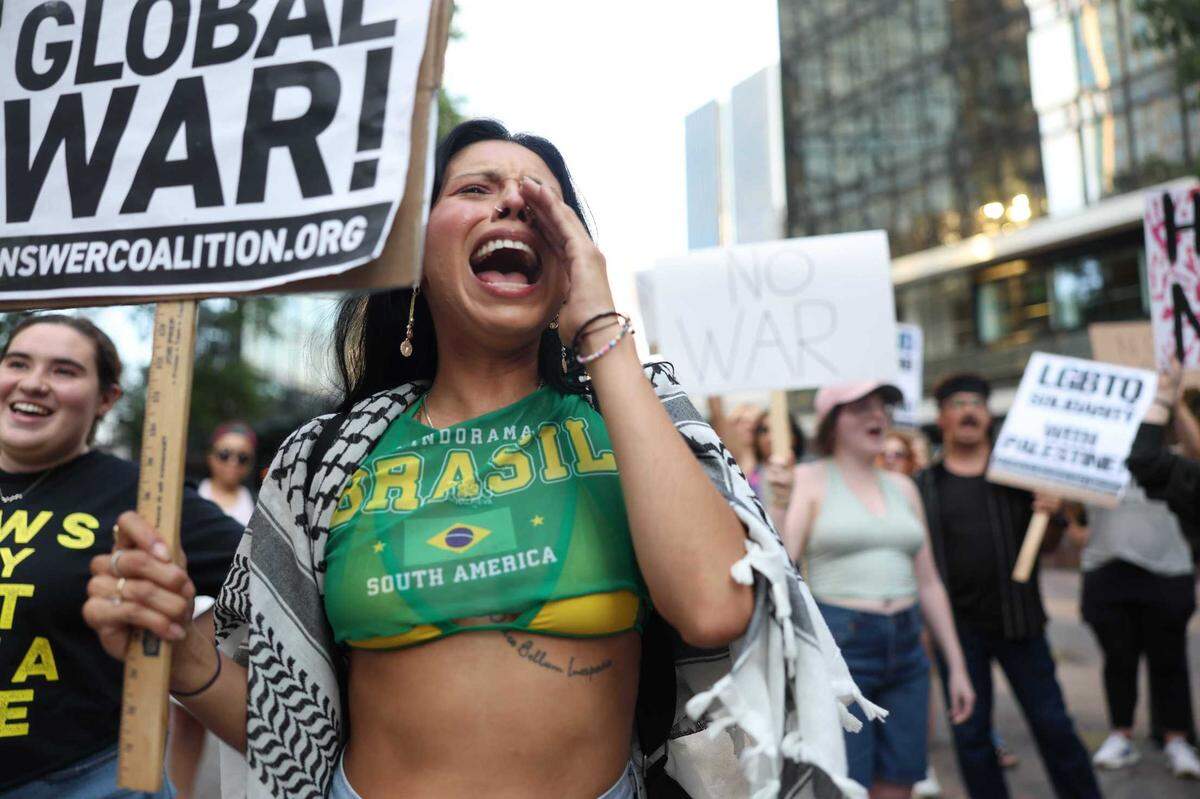 Katia Dominguez participates in the ‘No War on Iran!’ protest against war in the Middle East with an attack on Iran at Romare Bearden Park in Charlotte Thursday, June 26, 2025