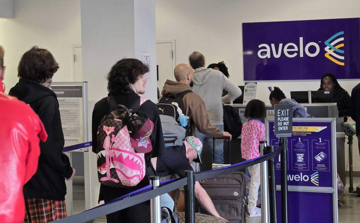 Avelo employees provide check-in services to customers going to San Juan, Puerto Rico.
